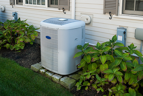 Spring Lake Air Conditioner Repair, Outdoor unit of a/c outside beige home