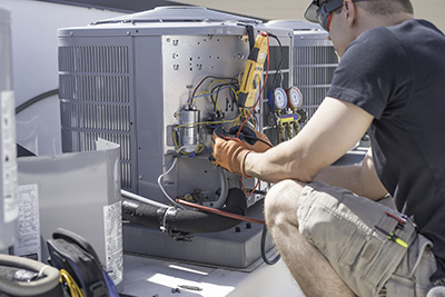 Spring Lake air conditioner repair specialist working on condenser